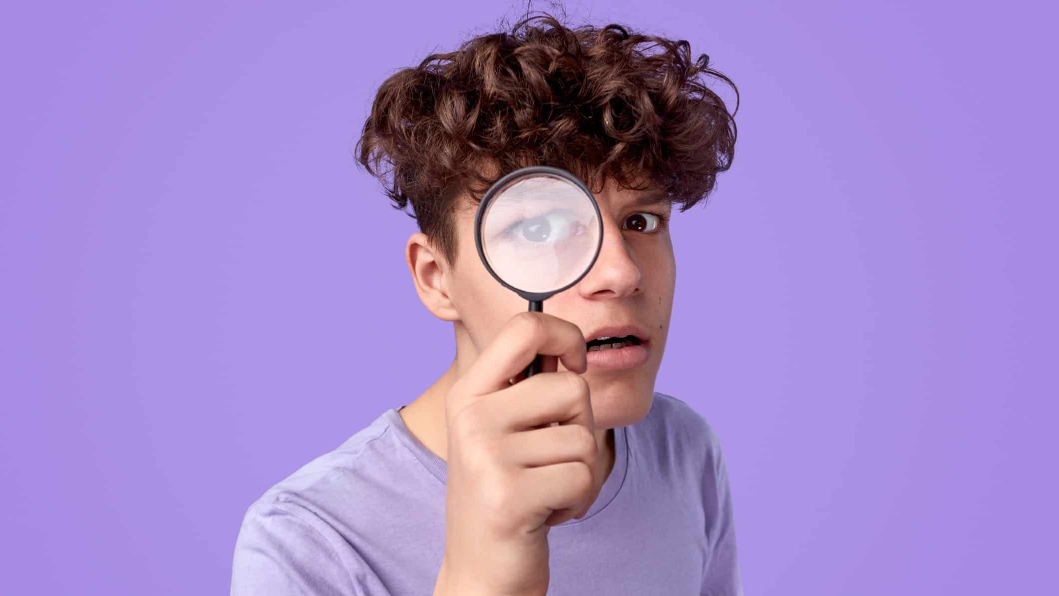 ASX share price on watch represented by man looking through magnifying glass