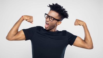 A fit man flexes his muscles, indicating a positive share price movement on the ASX market