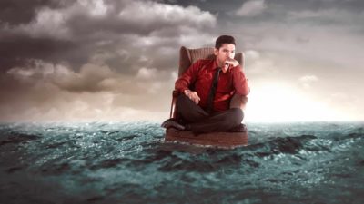 furniture asx share price represented by man in armchair floating on the sea