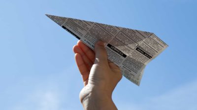 rising ASX share price represented by paper plane made from news paper