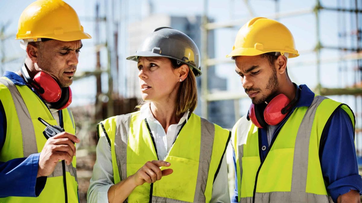 Two men and a woman in high vis gear on a Construction site