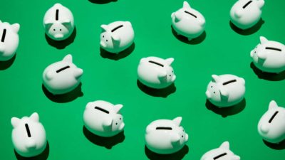 ASX bank share price represented by white Piggy Banks on green background