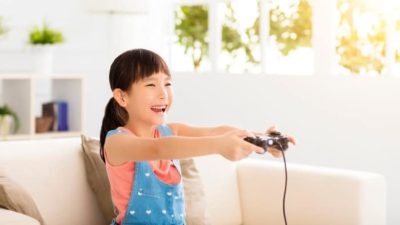 Smiling child playing video game
