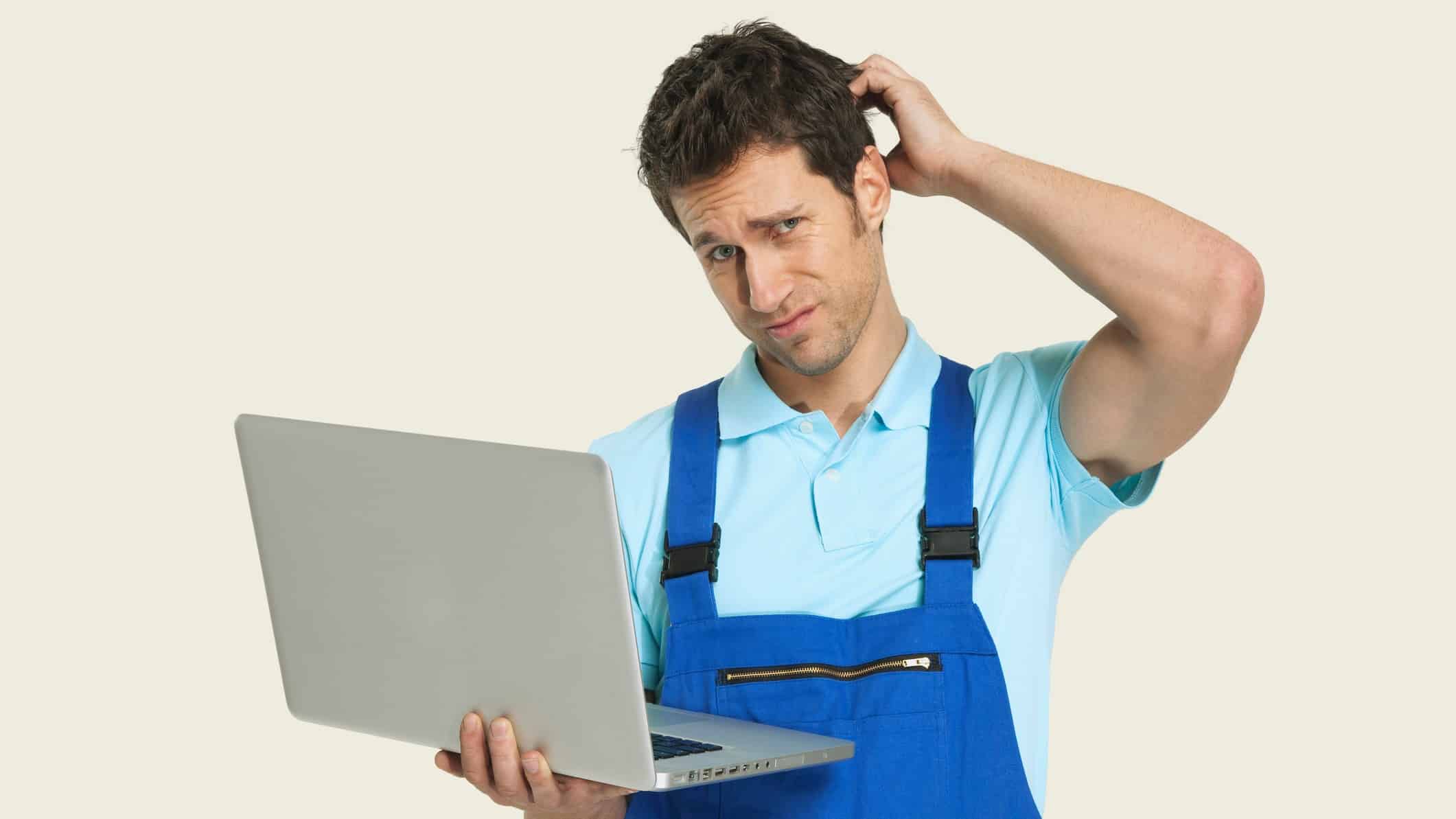 tradie holding a laptop computer displaying ASX share price and scratching his head looking confused