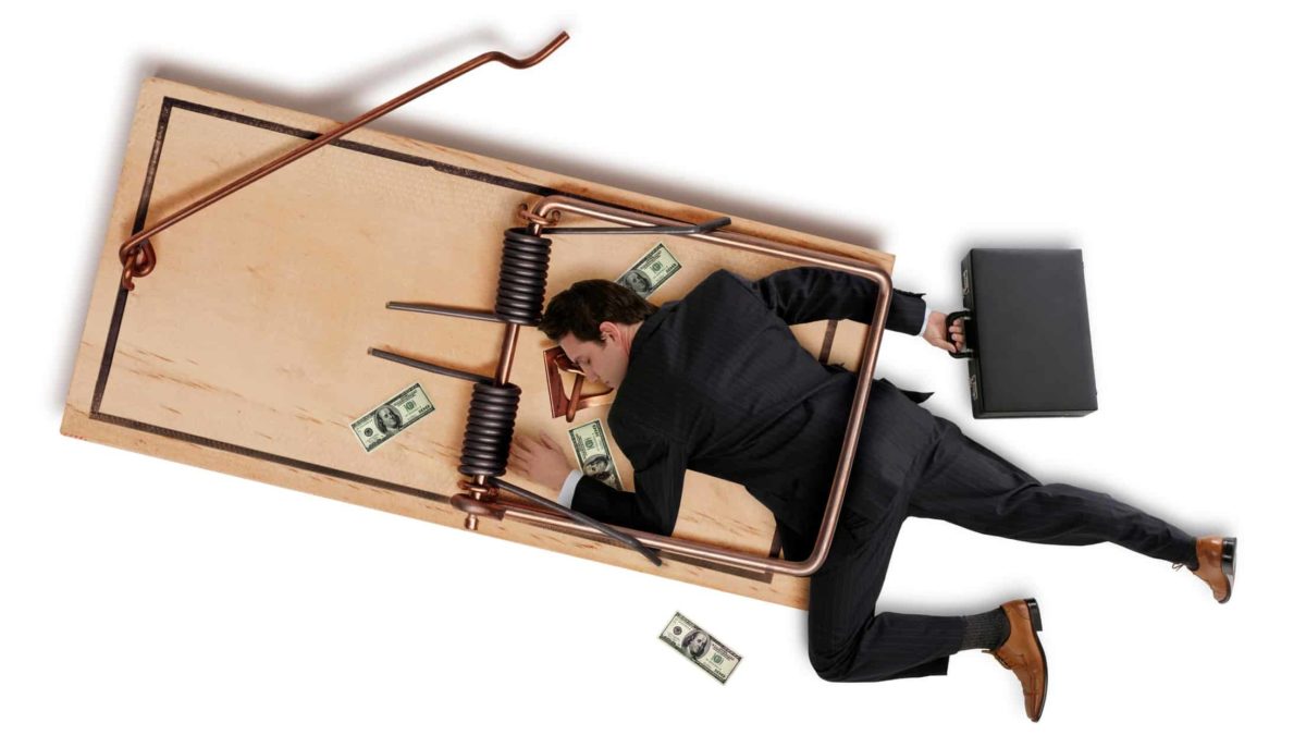 falling asx share price represented by investor stuck in mouse trap surrounded by money