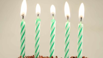 five asx shares represented by five candles on birthday cake