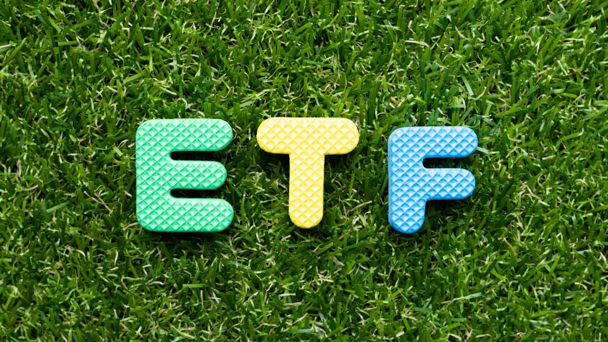 green etf represented by letters E,T and F sitting on green grass