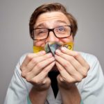 A man happily kisses a $50 note scrunched up in his hands representing the best ASX dividend stocks in Australia today