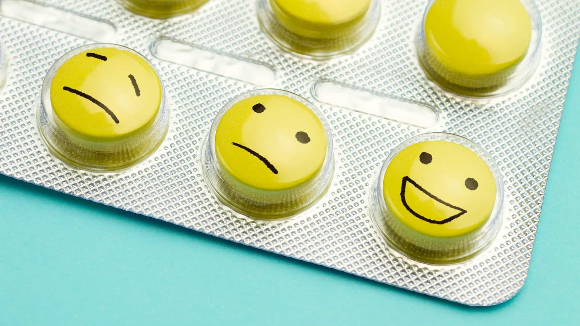 Three pills with faces showing sad to happy, indicating a rising share price for an ASX pharmaceutical company