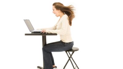 Aussie Broadband share price ASX share price rise represented by woman looking excitedly at computer screen