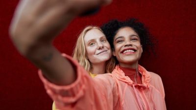 two smiling girls taking a selfie