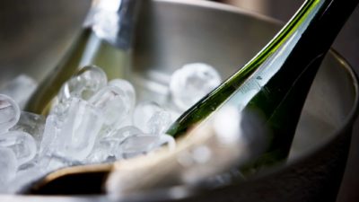 Bottles of wine or champagne on ice, indicating a trading halt or freeze for ASX wine companies