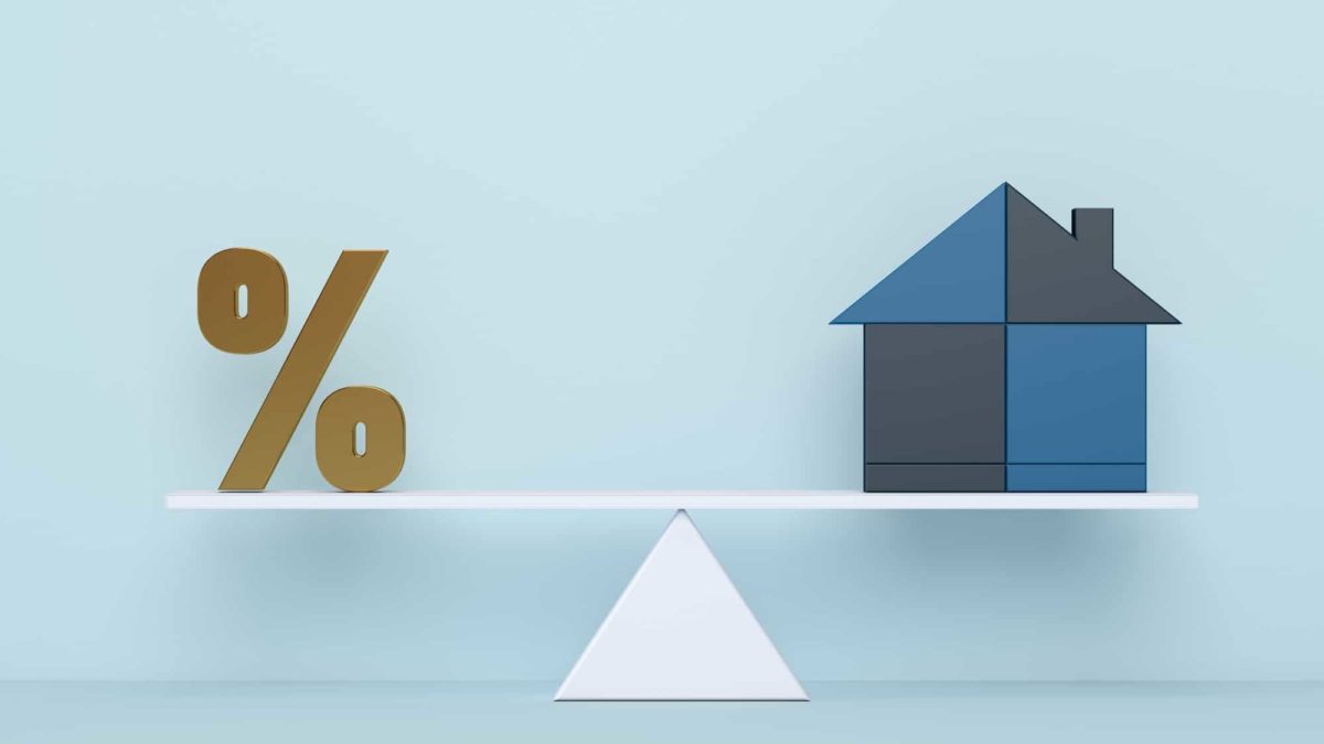 House and percentage symbol balancing on scales