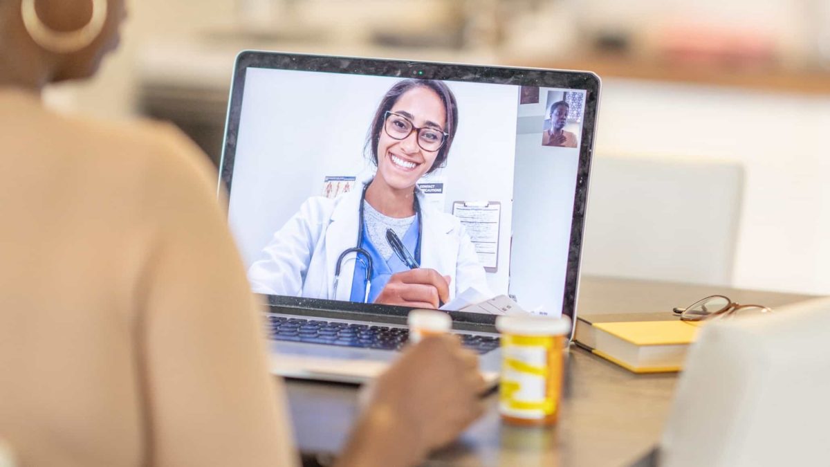 ASX healthcare digital disruption woman has medical consultation appointment video video call with her doctor.