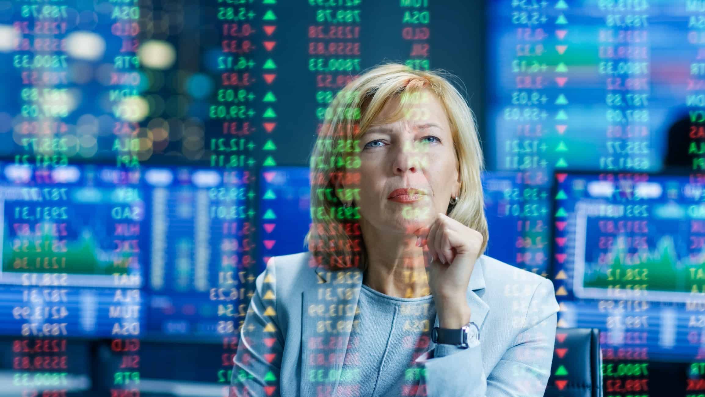 Business woman watching stocks and trends while thinking
