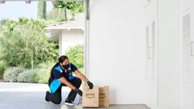 woman delivering Amazon prime parcel through in-garage grocery service