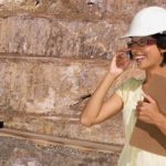 Female miner uses mobile phone at mine site