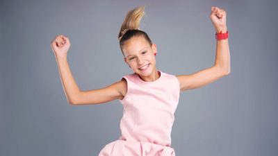 Jumping asx share price represented by young girl smiling and jumping up