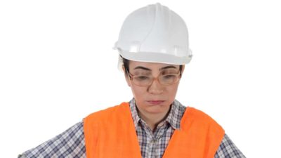 falling industrial asx share price represented by sad looking woman in hard hat