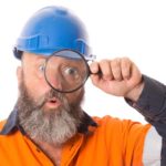 industrial asx share price on watch represented by builder looking through magnifying glass