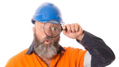 industrial asx share price on watch represented by builder looking through magnifying glass