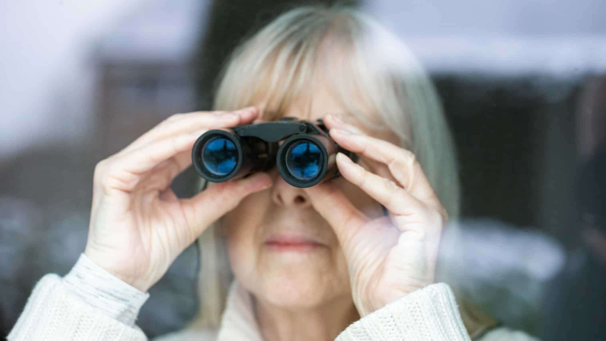 asx share price on watch represented by lady looking through pair of binoculars