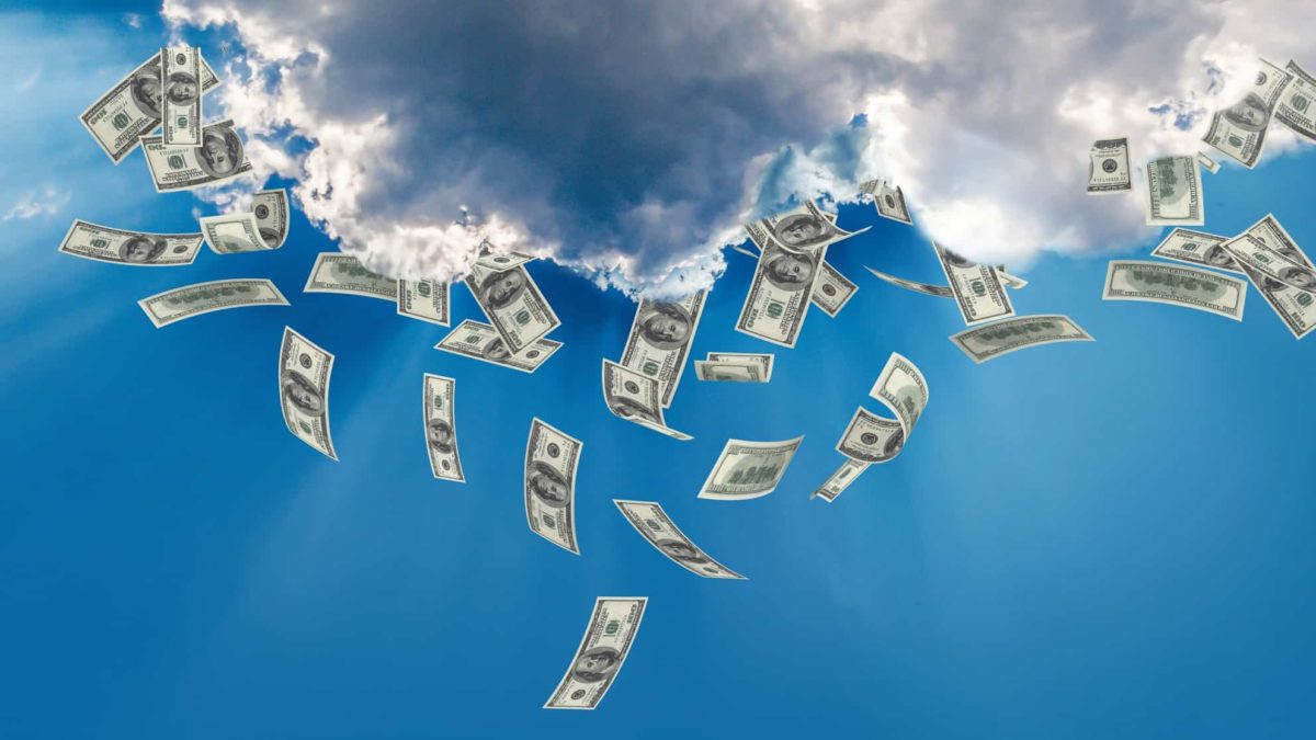 Cloud against blue sky with cash falling from it
