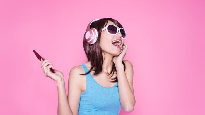 women listening to music with headphones on her head