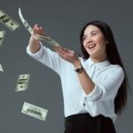 woman in white shirt splashing money in the air