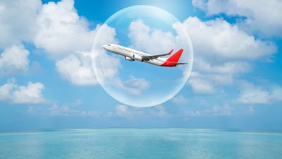 An airplane flying in a travel bubble, indicating share price movement for ASX travel companies