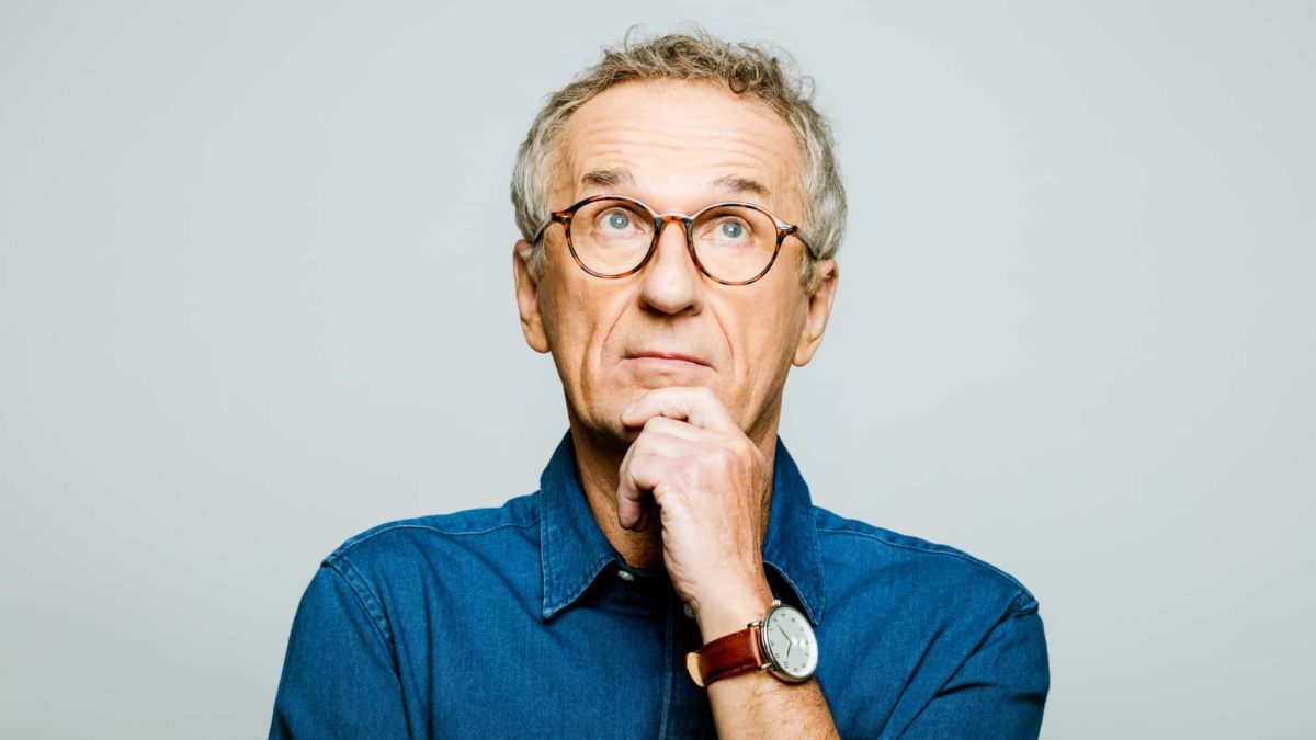 A mature aged man looks unsure, indicating uncertainty around a share price