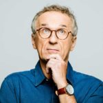 A mature aged man looks unsure, indicating uncertainty around a share price