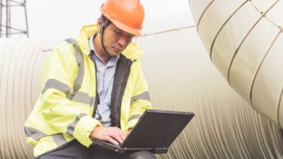 Natural gas plant engineers using laptop