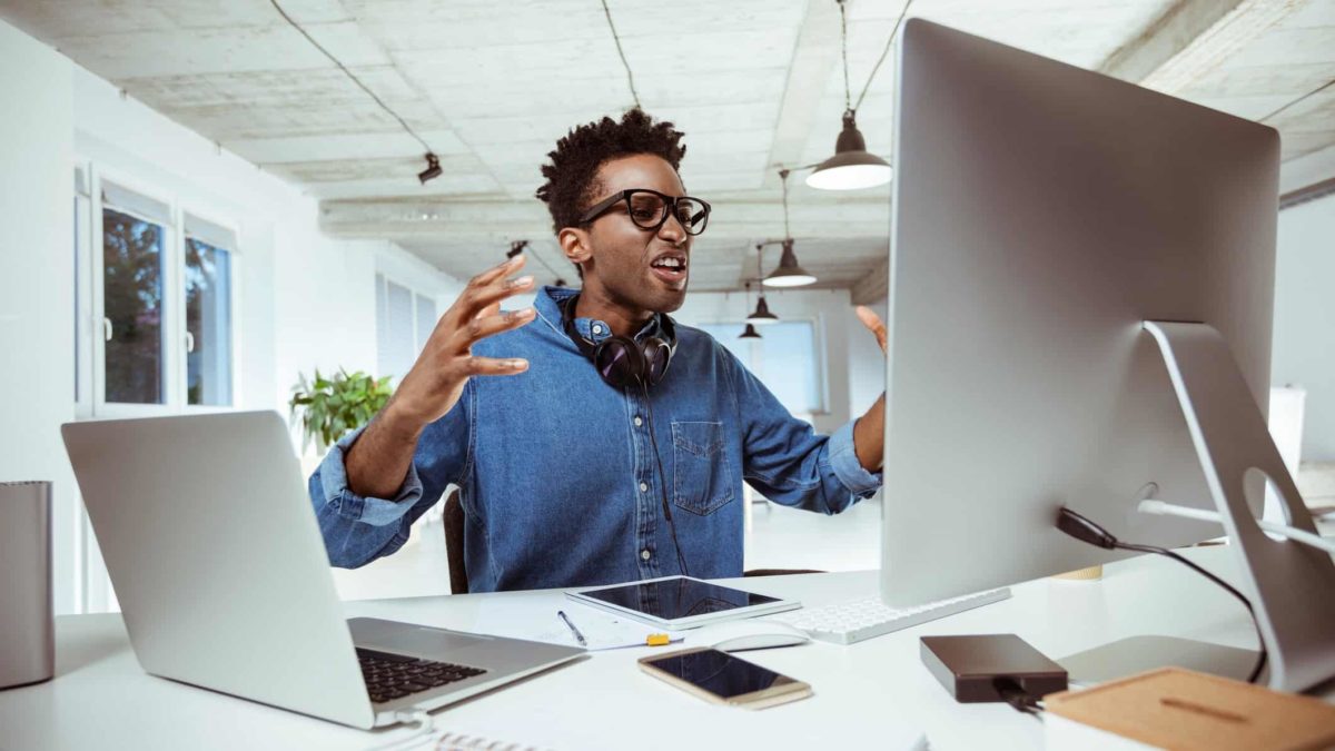 Frustrated man at computer desk