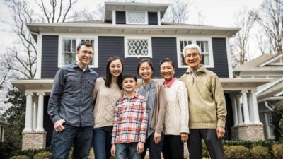 Multiple generations of a family in front of house