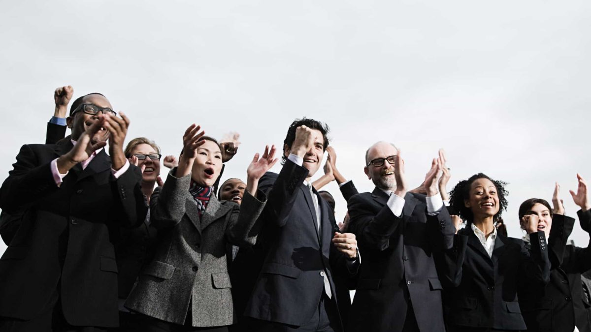 A group of business people cheering.
