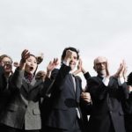 A group of business people cheering.