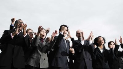 A group of business people cheering.