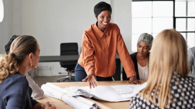 Group of executives meeting around a board table