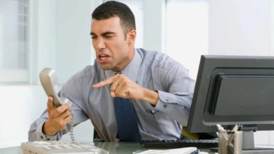 Man upset and pointing at his phone