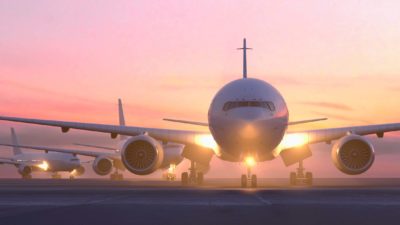 An aeroplane at an airport taxiing down the runway symbolising the improving Flight Centre share price