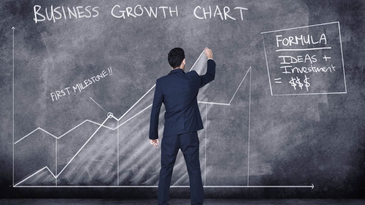 rising asx share price represented by man drawing growth chart on blackboard