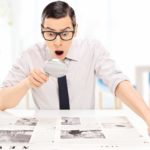 a surprised investor reading about an asx share price in a newspaper