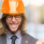 Man in hard hat making excited fists.