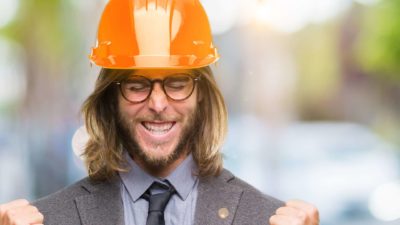 Rising mining ASX share price represented by man in hard hat making excited fists