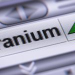 rising asx uranium share price icon on a stock index board