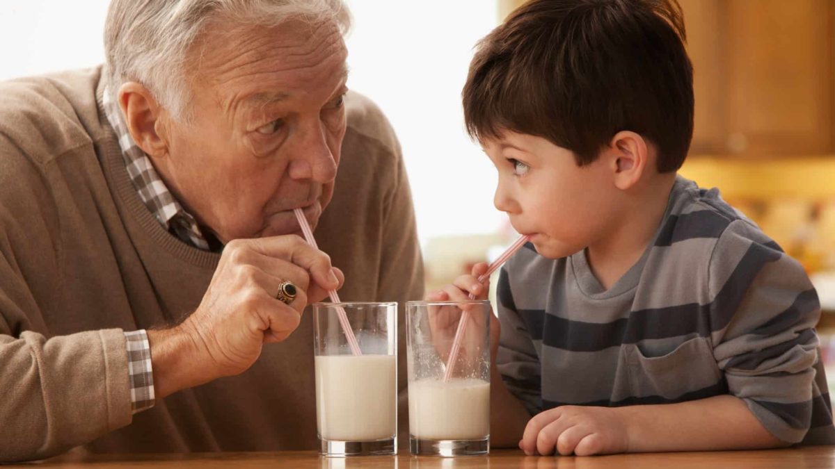 dairy asx share price represented by grandfather and grandson both drinking glasses of milk