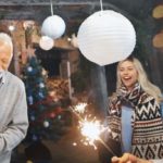 man celebrating with bottle of champagne at a party