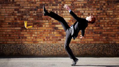 Man slipping over on banana skin