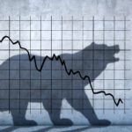 A shadow bear faces a man against the backdrop of a falling share price.